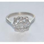 A diamond cluster ring, open shield crest inset with nine round brilliant cut diamonds,