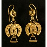 A pair of seed pearl accented horse shoe and stirrup drop rose metal earrings, hook fittings,