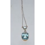 A blue topaz rectangular cushion and round cut two stone pendant necklace, yellow metal frame,