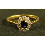 A sapphire and diamond cluster ring, central oval blue sapphire approx 0.