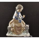 NAO FIGURINE GIRL SEATED WITH FLOWER POT AND 2 BIRDS,