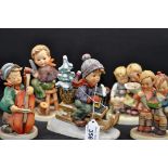 5 WEST GERMANY GOEBEL HUMMEL FIGURINES - BOY PLAYING CELLO, SMALL CHIP TO THE BASE,