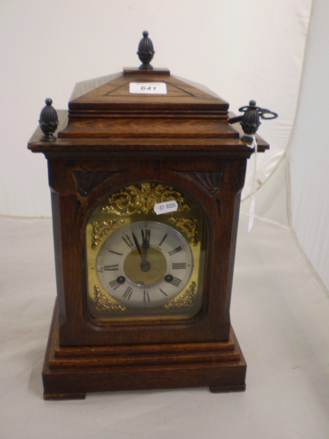 MANTLE CLOCK IN OAK CASE WITH ACORN FINIAL'S WITH KEY