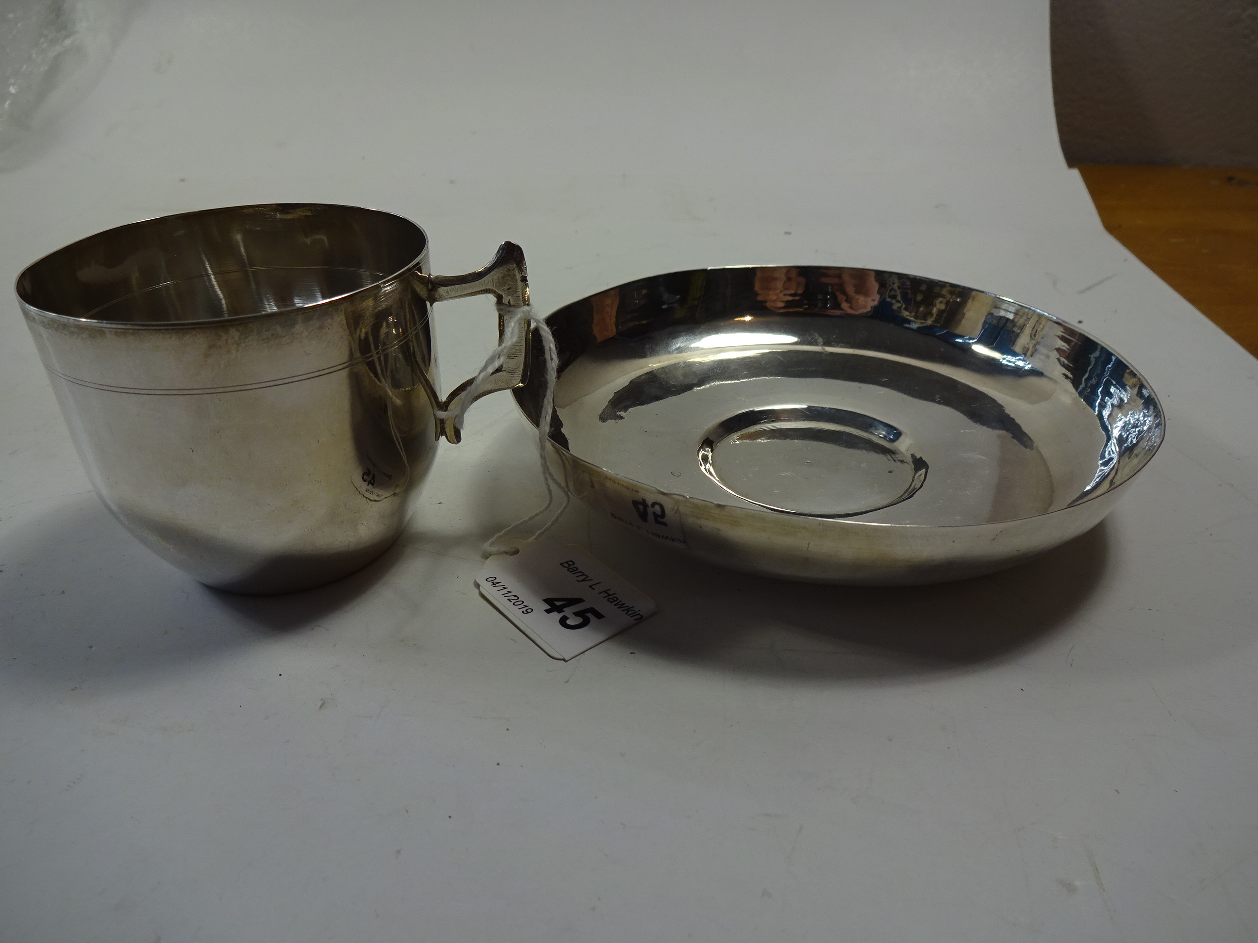 SILVER PLATED CUP AND SAUCER