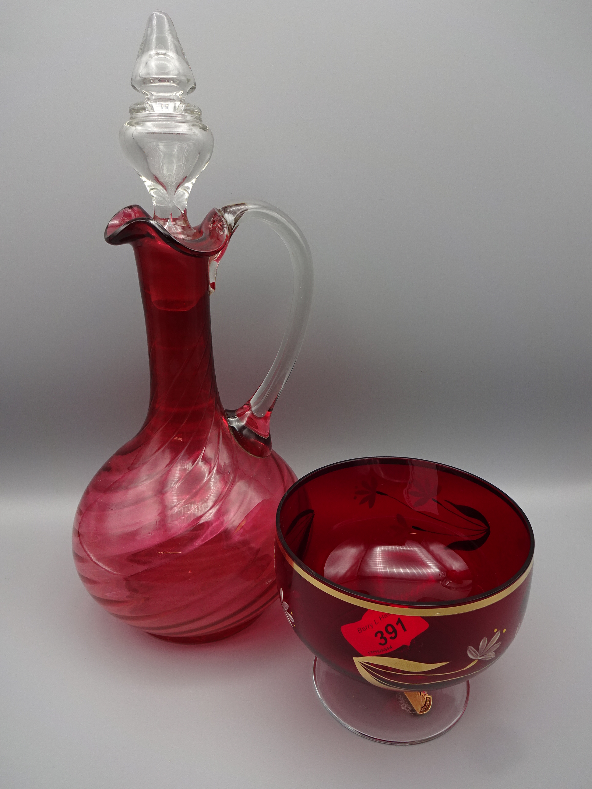 9 PIECES CRANBERRY GLASS INCLUDING PAIR OF DECANTERS