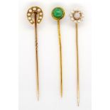 A group of three gold and gemstone stick pins