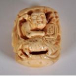 Vintage carved ivory netsuke of man & fish