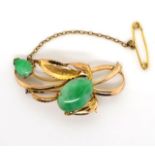 Gold and jade brooch