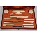 A vintage boxed ivory manicure set