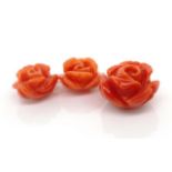 Three loose Italian coral carved roses