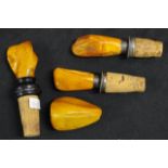 Three Baltic amber topped bottle stoppers