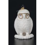 Bone figure of a owl with metal glasses