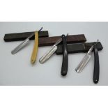 Three vintage cut throat razors