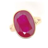 Treated oval cut ruby set 18ct yellow gold ring