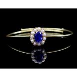 3.00ct Blue sapphire, seed pearl set gold bangle