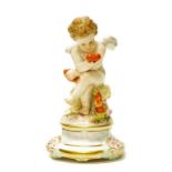 Antique Meissen porcelain seated cupid figure