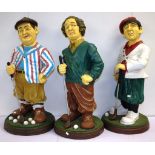 Three large golfing figures of The Three Stooges