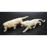 Two Chinese carved ivory lion & lioness figures