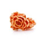 A well carved coral and gold brooch