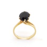 Black gemstone and gold ring