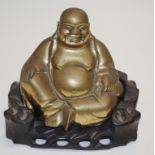 Chinese brass seated Budai figure & stand