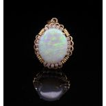 A large white opal, diamond and 14ct gold pendant