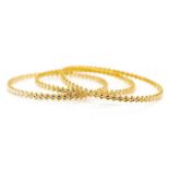 Three two tone gold bangles