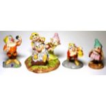 Four Royal Doulton "Snow White" figurines