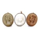 Three bacchanalia carved lava pendants