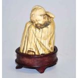 Carved ivory figure of a sleeping man