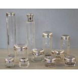 Eleven silver topped dressing table jars