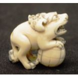 Early carved Ivory Foo dog on ball netsuke