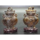 Pair of Chinese tigers eye lidded urns