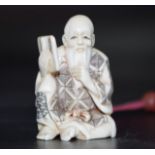 Early carved Ivory seated sage reading nesuke