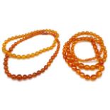 Two amber beaded necklaces and two faux examples