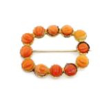 Antique yellow gold brooch set with carved coral