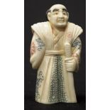 Early carved Ivory sage holding a stick figure