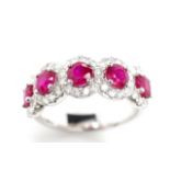Five stone ruby and diamond halo ring
