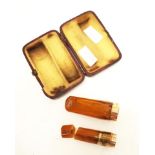 Two amber & 9ct gold rimmed cheroot holders