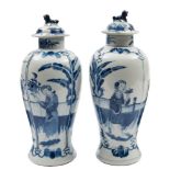 A pair of Chinese blue and white baluster vases and covers: with lion dog finials,