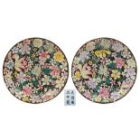A pair of Chinese famille noire millefleur dishes: each painted with full blown flowers and foliage
