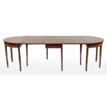 A George III mahogany D-end dining table in three parts:,
