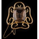 A smoky quartz single-stone brooch: the central,