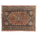A Quashgai rug:, the shaded brick red field with a central indigo stepped medallion,