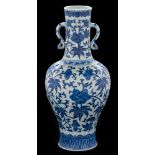 A Chinese blue and white vase: of baluster form with waisted slender neck and ruyi handles,