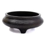 A small Chinese Islamic market bronze tripod censer: cast on each side with a panel of Islamic