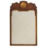 A 19th Century walnut and partly gilt mirror:, in the 18th Century manner,