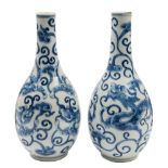 A pair of Chinese blue and white bottle vases: each painted with opposing dragons amongst lingzhi