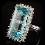 An aquamarine and diamond long rectangular cluster ring: with central step-cut aquamarine 23.
