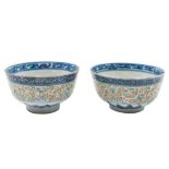 A pair of Chinese rice bowls: painted in underglaze blue, iron red,